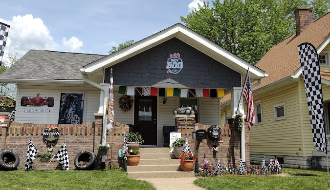 A house in Marion County decorated with racing flags and Indy 500 signs, cared for by Damage Restoration Service.
