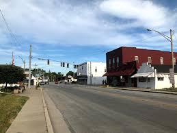 A quiet small-town street in Hamilton County with shops, traffic lights, and a Water Damage Restoration Service.